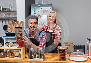 Barista coffee shop owner couple happy smile at bar counter