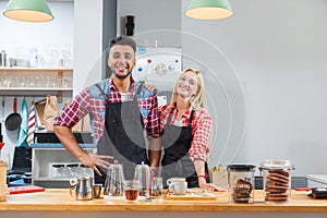 Barista coffee shop owner couple happy smile at bar counter