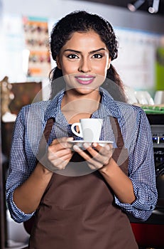 Barista with espresso in Indian cafe