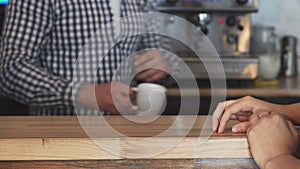 The barista gives the client an order