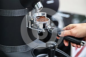 Barista grind coffee beans into the portafilter