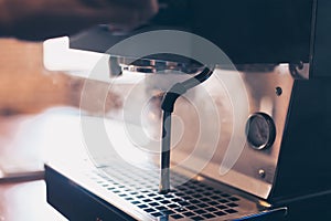 Barista heats milk steam for making lattes at coffee shop