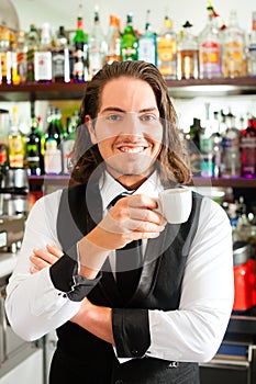 Barista in his cafe or coffeeshop photo