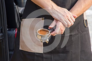 Barista holds coffee strainer