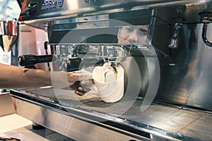 Barista made drink by coffee machine with vintage tone.