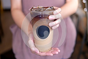 Barista made the fresh ice coffee latte. cold refreshment with the template sticker logo