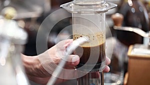 Barista make a cup of coffee, Aeropress model.