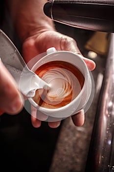 Barista makes coffee latte art