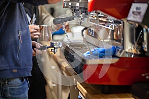 Barista makes coffee in the coffee machine