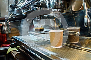 Barista makes fresh and tasty coffee on a coffee machine