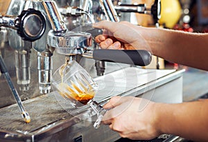 Barista making cappuccino with coffee machine.