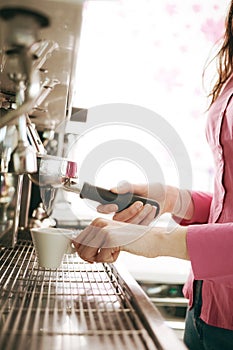 Barista making coffee with a coffee machine