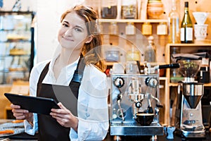 Barista making coffee at small cafe.