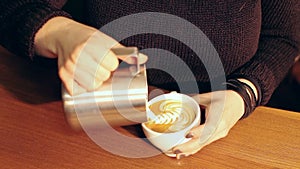 Barista making a cup of hot coffee, free puring latte art