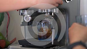 A barista making espresso with a coffee machine