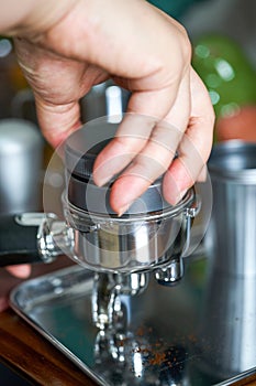 A barista making espresso with a coffee machine