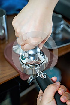 A barista making espresso with a coffee machine