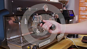 Barista making fresh coffee from coffee machine.