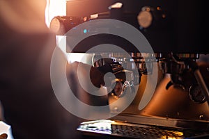 Barista making fresh coffee with coffee machine in cafe