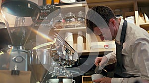 Barista is making milk cappuccino with coffee machine in the shop or cafe bar