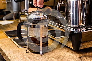 Barista making non traditional coffee in french press
