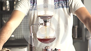 Barista making syphon coffee, syphon coffee is a new way to brew third generation americano