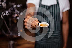 Barista offering an espresso