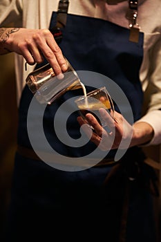 Barista pouring milk in coffee cup for make latte art