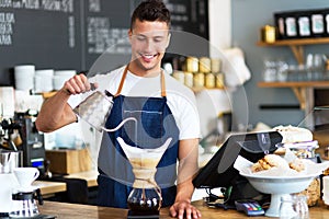 Barista pouring water into coffee filter