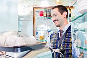 Barista preparing coffee or espresso in cafe bar