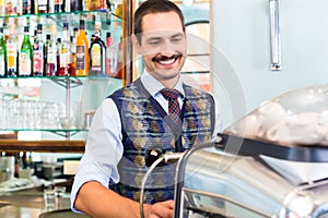 Barista preparing coffee or espresso in cafe bar