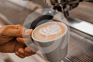 Barista putting tamper in coffee machine