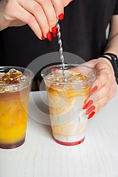 Barista& x27;s hands prepare summer cocktails with ice and coffee