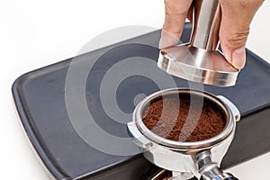 Barista is tamping coffee ground on the rubber, prepare to brew