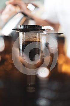 Barista use plastic vacuum tube to press americano