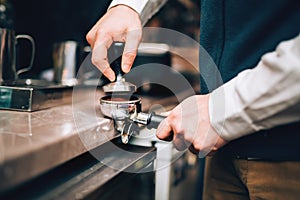 Barista using coffee machine preparing fresh coffee with latte foam at coffee shop and restaurant