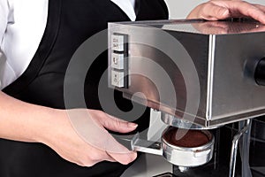 Barista using an espresso machine.