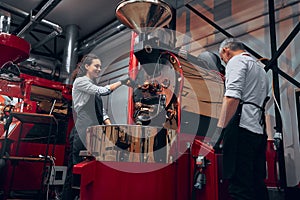 Baristas creating coffe in the modern coffe machine. Low angle