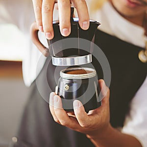 Baristas prepare hot coffee beans in cup pot. to make coffee for steam. Coffee shop concept. in cafe shop for drink,small business