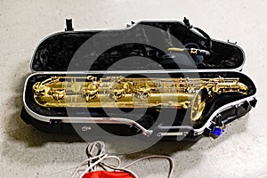 Baritone saxophone settled into it`s case all ready to go or to