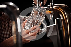 Barkeeper pulling a pint of beer behind the bar