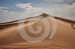 Barkhans of the Sahara desert. Tent in the sand. People in the desert