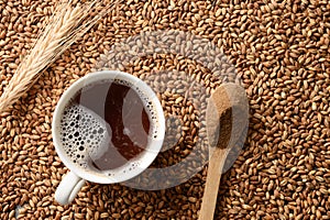 Barley coffee in white cup and ears of barley.