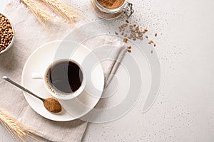 Barley coffee in white cup and ears of barley on white background.