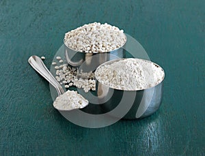 Barley flour in a steel bowl and on spoon