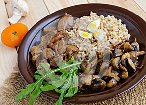 Barley porridge, fried mushrooms and duck liver, boiled quail eggs, tomatoes, arugula - healthy food