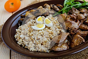 Barley porridge, fried mushrooms and duck liver, boiled quail eggs, tomatoes, arugula - healthy food