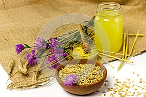 Barley seeds in wooden bowl, honey and traditional slavic slavonic barley or rye drink Kvas