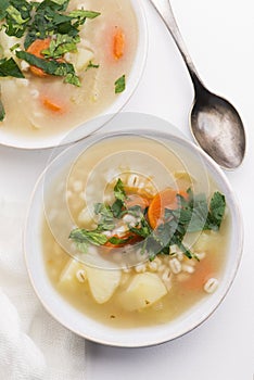 Barley soup, pearl barley in white bowl