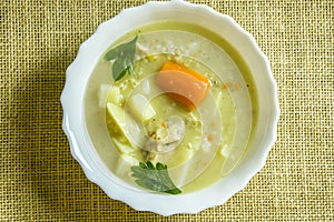 Barley soup in a white bowl.